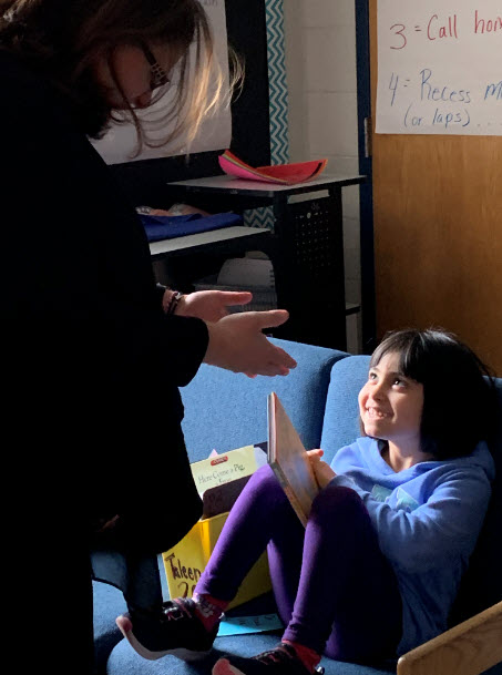 school board member reading with student